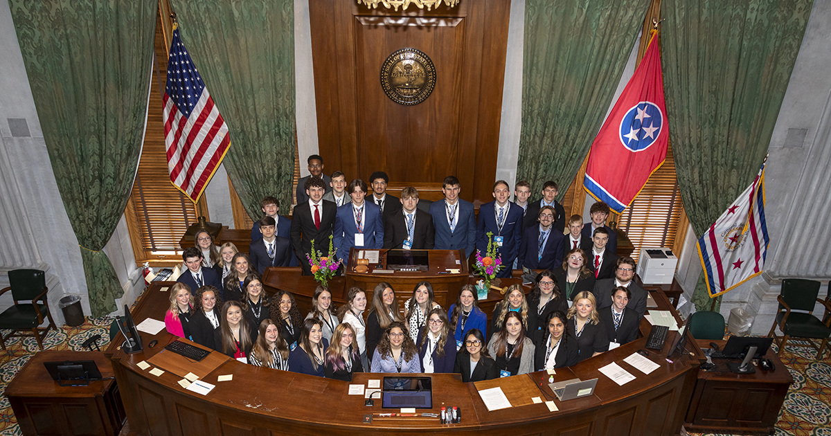 Photograph showing 46 high school juniors dressed professionally and posing in the chambers of the Tennessee State Senate