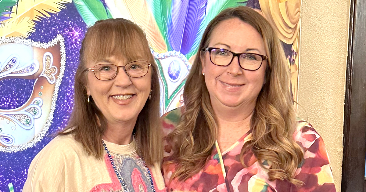 Photo of two women smiling at the camera.