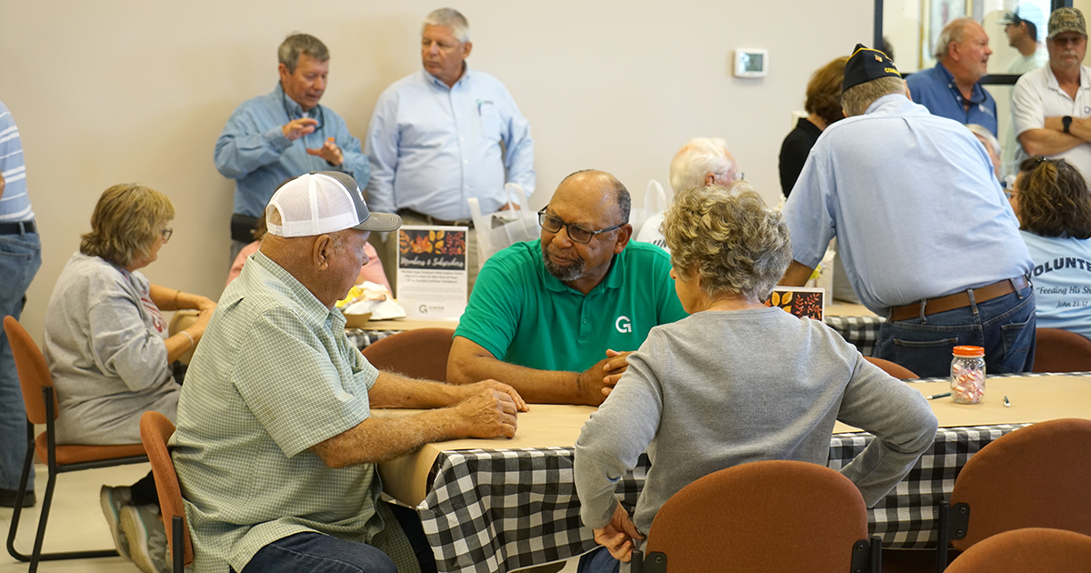 People sitting around tables talking
