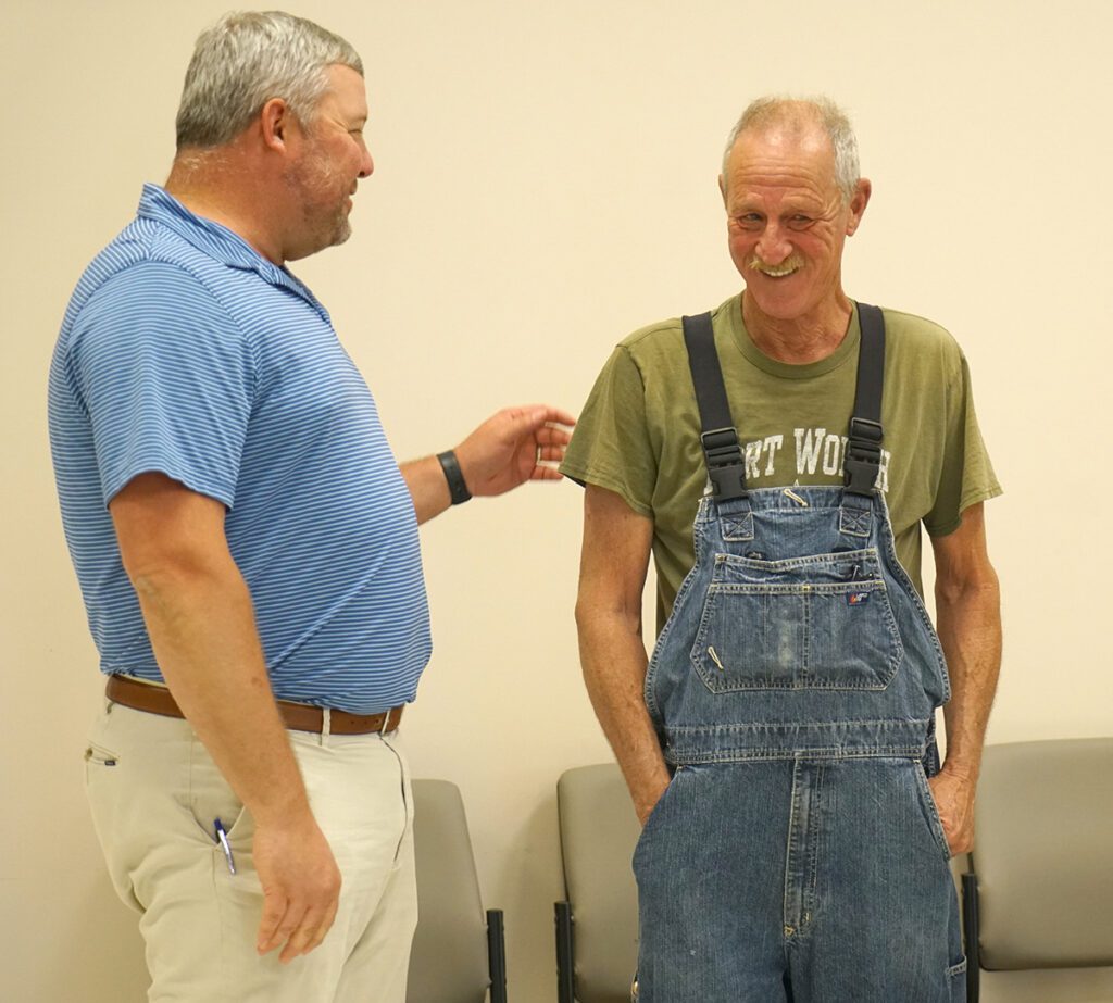 Jeff Fox speaks with a guest at his retirement reception.