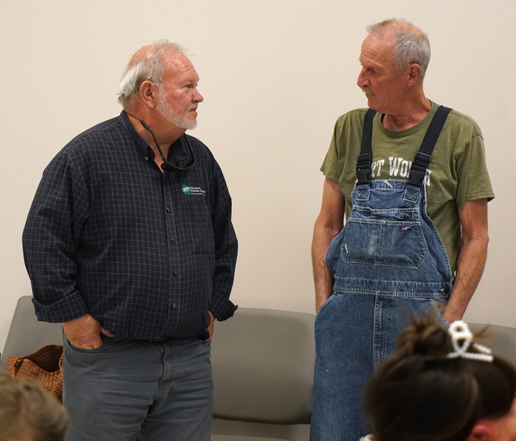 Jeff Fox speaks with a guest at his retirement reception.