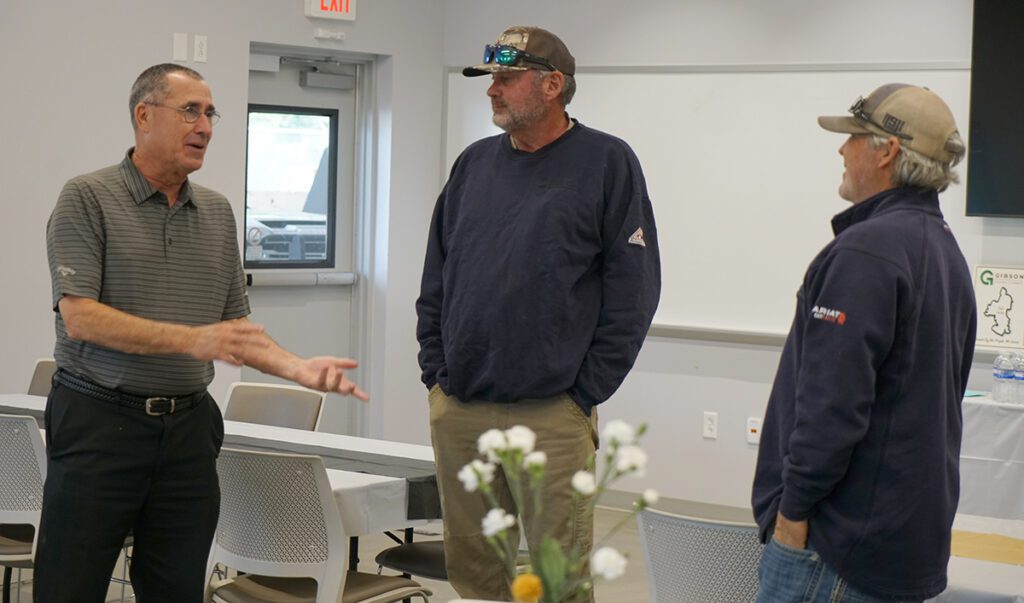 Dan Rodamaker visits with guests at his retirement reception.