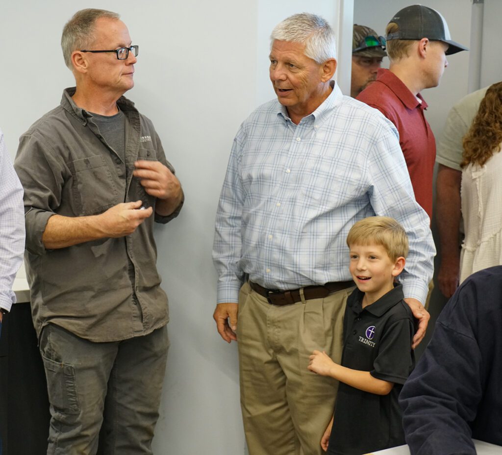 Barry Smith and his grandson visit with guests at his retirement reception.