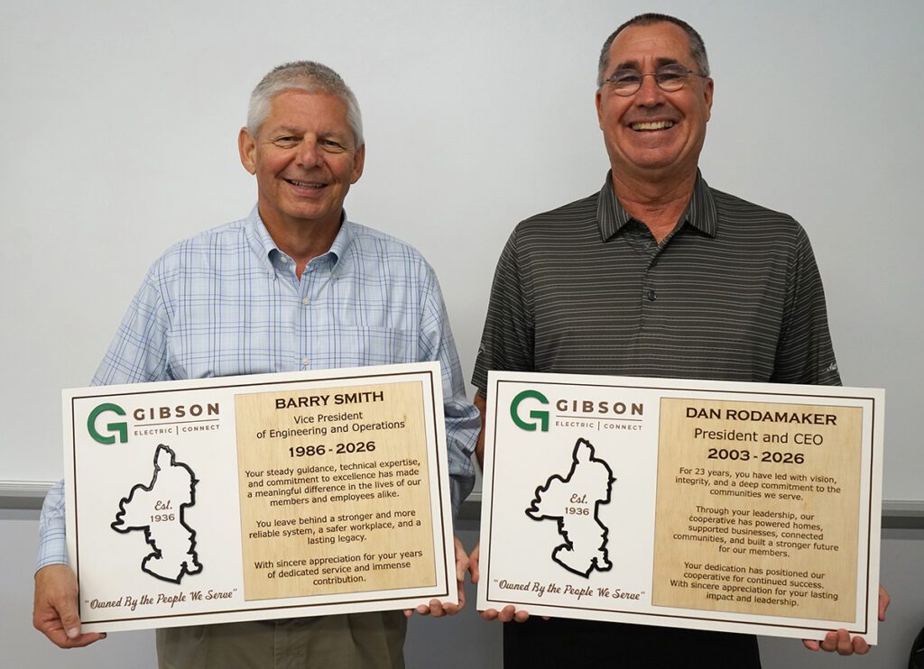 Barry Smith and Dan Rodamaker pose with plaques commemorating their time with Gibson Electric.