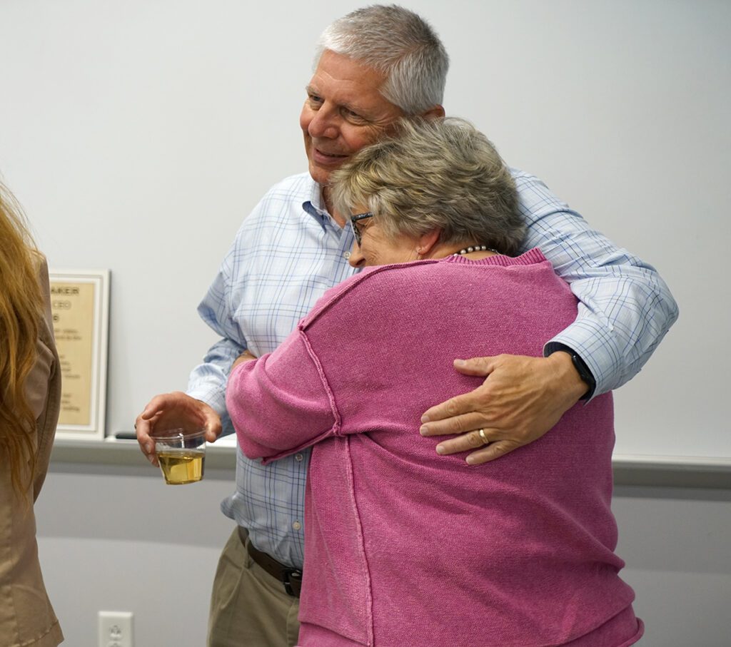 Barry Smith visits with a guest at his retirement reception.